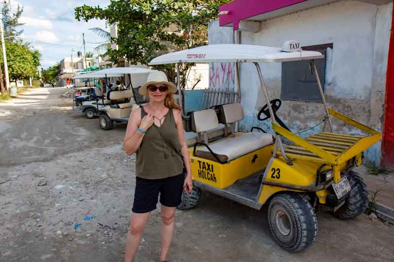 Sarah next to golf car